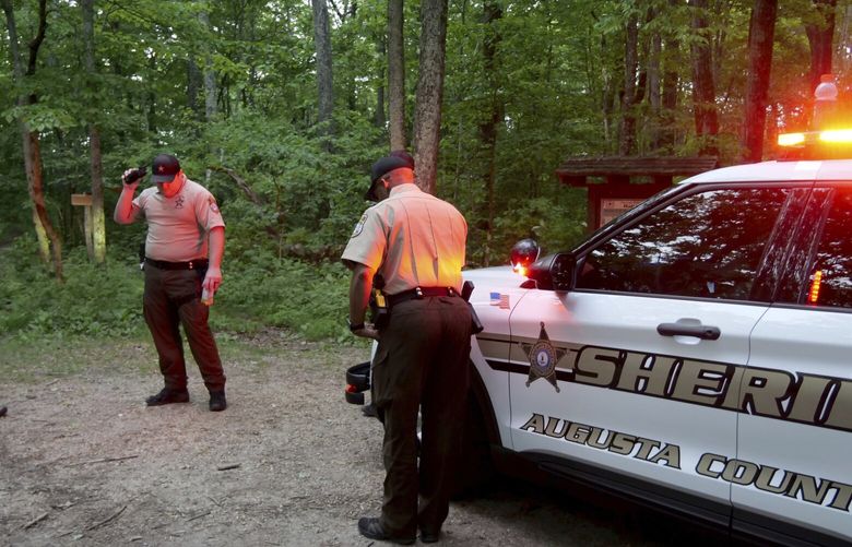 Authorities secure the entrance to Mine Bank Trail, an access point to the rescue operation along the Blue Ridge Parkway where a Cessna Citation crashed over mountainous terrain near Montebello, Va., Sunday, June 4, 2023. (Randall K. Wolf via AP) NYSB755 NYSB755