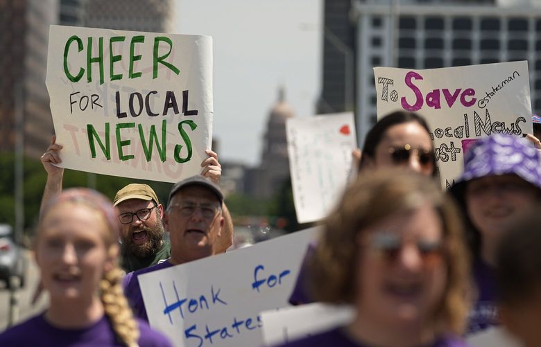 Editorial members of the Austin American-Statesman’s Austin NewsGuild picket along the Congress Avenue bridge in Austin, Texas, Monday, June 5, 2023. The mostly one-day strike aims to protest the company’s leadership and cost-cutting measures imposed since its 2019 merger with GateHouse Media. (AP Photo/Eric Gay) 