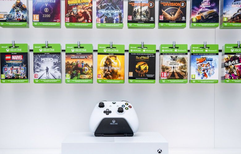 An Xbox One controller sits on display below Microsoft gaming passes in 2019. 