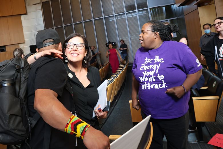 Seattle City Councilmember Tammy Morales hugs Renaissance, left, a community organizer from the groups 350 Seattle and Whose Streets, Our Streets after the council voted against an ordinance to give the city attorney prosecution power on public drug use and drug possession cases in Seattle on Tuesday, June 6, 2023. (Karen Ducey / The Seattle Times)