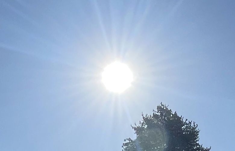 The sun creeps upward in a cloudless sky Tuesday morning, June 6, 2023, in Shoreline.