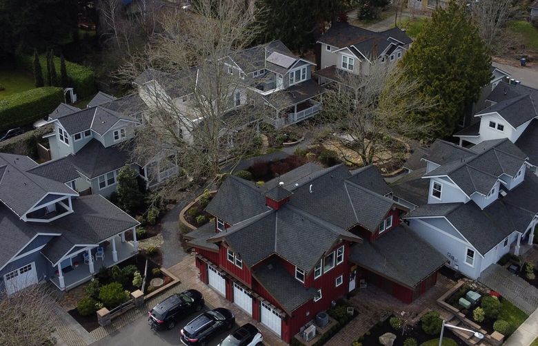 Nine homes make up the Juanita Farmhouse Cottages development, seen from the air, Thursday, March 9, 2023 in Kirkland. Kirkland gives developers a choice to build lots with single or multiple dwellings, hoping to spur middle housing choices in the long-term for future buyers.