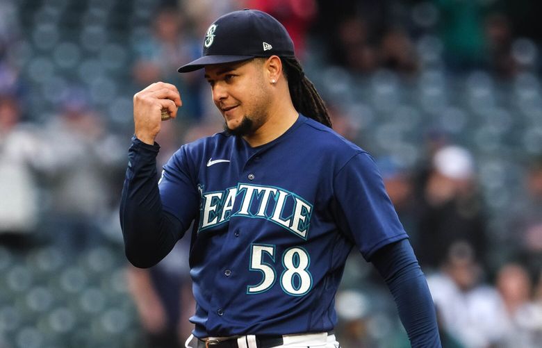 Luis Castillo acknowledges his teammates in the dugout after striking out Oakland’s Shea Langeliers for his 1000th career strikeout. 223889
