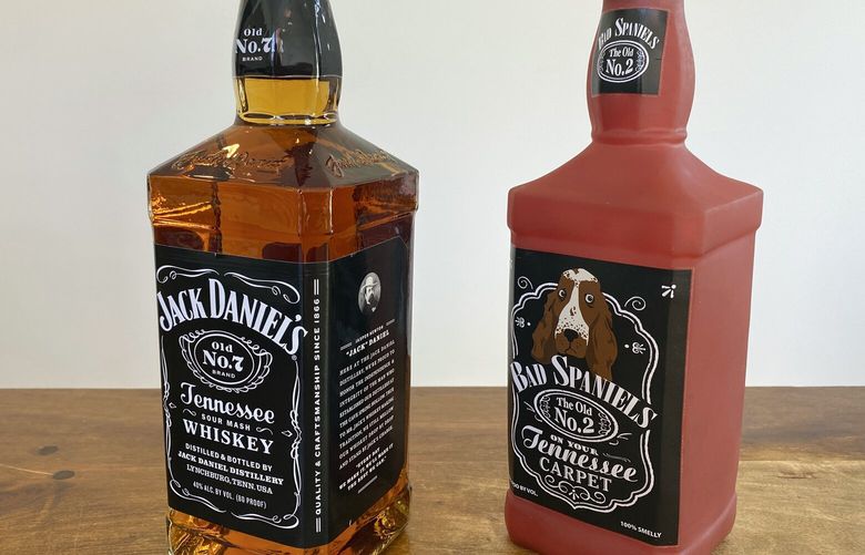 FILE – A bottle of Jack Daniel’s Tennessee Whiskey is displayed next to a Bad Spaniels dog toy in Arlington, Va., Sunday, Nov. 20, 2022. The Supreme Court on Thursday, June 8, 2023, gave whiskey maker Jack Daniel’s reason to raise a glass, handing the company a new chance to win a trademark dispute with the makers of the Bad Spaniels dog toy. In announcing the decision for a unanimous court, Justice Elena Kagan was in an unusually playful mood. Observers who watched her read a summary of the opinion in the courtroom said she held up the dog toy at one point. (AP Photo/Jessica Gresko, File) WX110 WX110