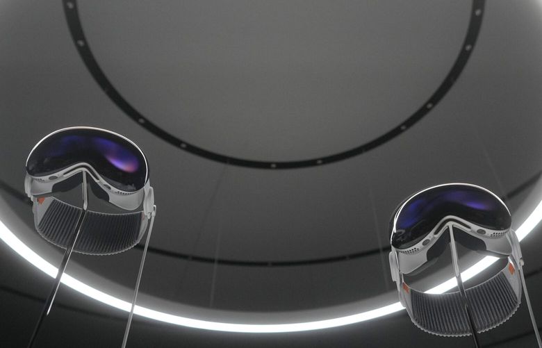 A pair of Apple Vision Pro headsets are displayed in a showroom on the Apple campus Monday, June 5, 2023, in Cupertino, Calif. (AP Photo/Jeff Chiu) CAMS141 CAMS141