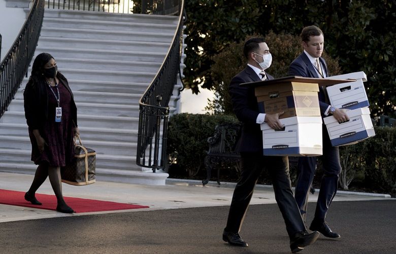 FILE — Aides move boxes out of the White House as President Donald Trump prepares to board Marine One on his last day as president, in Washington on Jan. 20, 2021. The Justice Department has spent months trying to ensure it had obtained all classified documents that may have ended up at Mar-a-Lago. (Anna Moneymaker/The New York Times) XNYT0767 XNYT0767