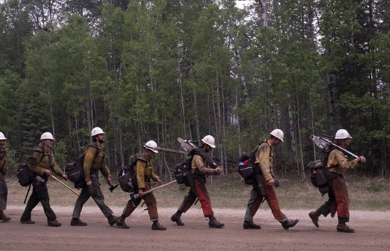 FILE – A group of hotshot firefighters from Boise, Idaho, who traveled from the United States to fight the wildfires in Alberta, return to their trucks after completing a prescribed burn, in Shining Bank, Alberta, Canada, May 19, 2023. Budget cuts, a loss of some of Canada’s forest service staff and onerous rules for fire prevention have put forests and lives at risk. (Jen Osborne/The New York Times) XNYT0088 XNYT0088