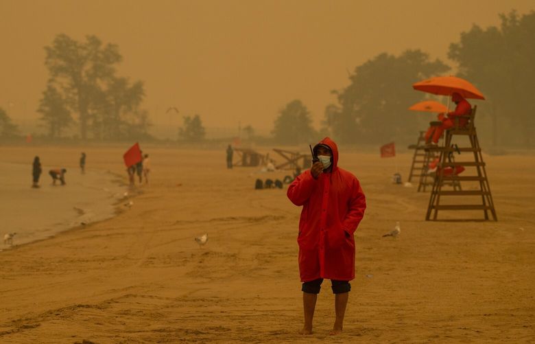 Lifeguards watch over a nearly empty Orchard Beach in the Bronx amid haze from wildfire smoke on Wednesday, June 7, 2023. While many of the  Republican presidential candidates acknowledge that climate change is real, they largely downplay the issue and reject policies that would slow rising temperatures. (Gregg Vigliotti/The New York Times) XNYT0366 XNYT0366