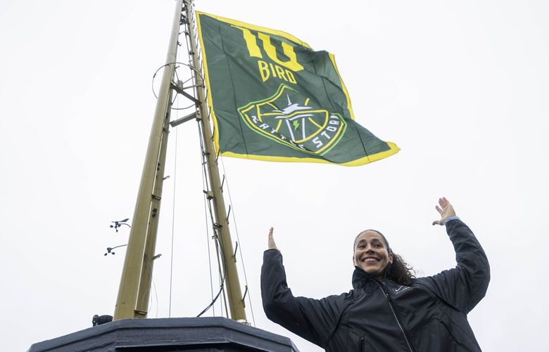 Sue Bird poses for members of the media after she raised a replica of her jersey retirement banner on top of the Space Needle in Seattle, Wash. on Friday, June 9, 2023.