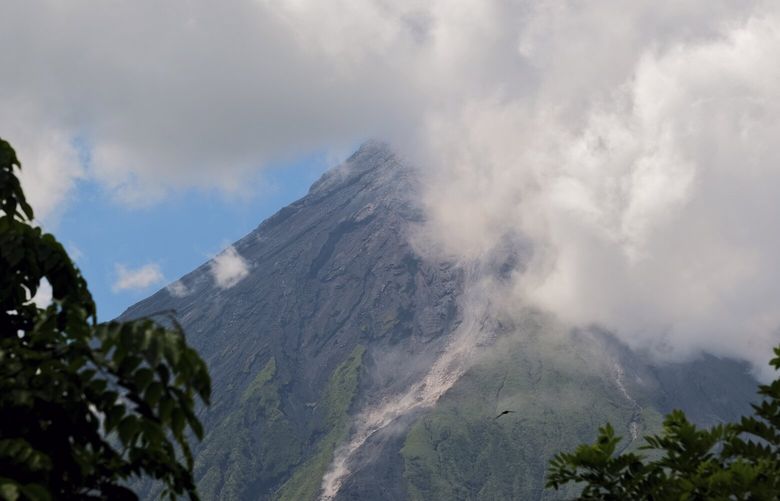 Mayon Volcano spews white smoke as seen from Daraga, Albay province, central Philippines on Thursday June 8, 2023. The Philippine Institute of Volcanology and Seismology raised Thursday the status of Mayon Volcano in Albay to Alert Level 3 due to “increased tendency towards a hazardous eruption.” (AP Photo/John Michael Magdasoc) XAF101 XAF101