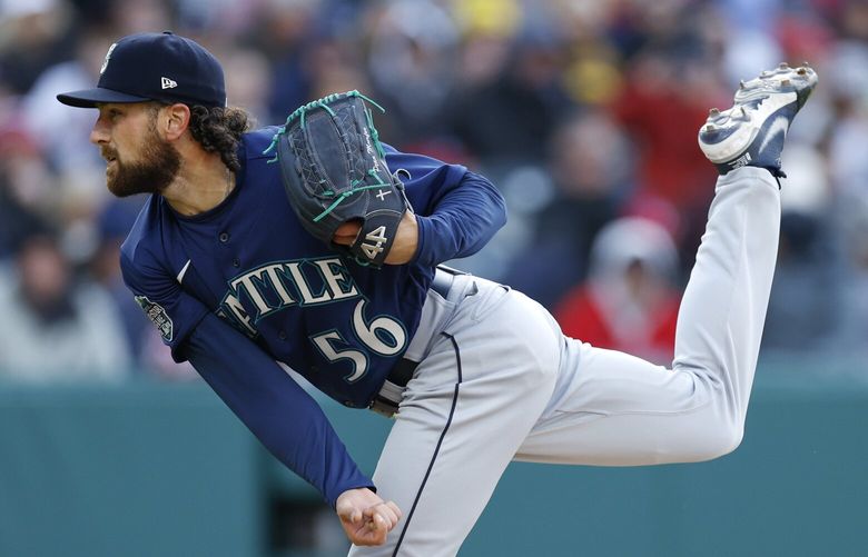 Seattle Mariners relief pitcher Penn Murfee watches a throw to a Cleveland Guardians batter during the fifth inning of a baseball game Friday, April 7, 2023, in Cleveland. (AP Photo/Ron Schwane)