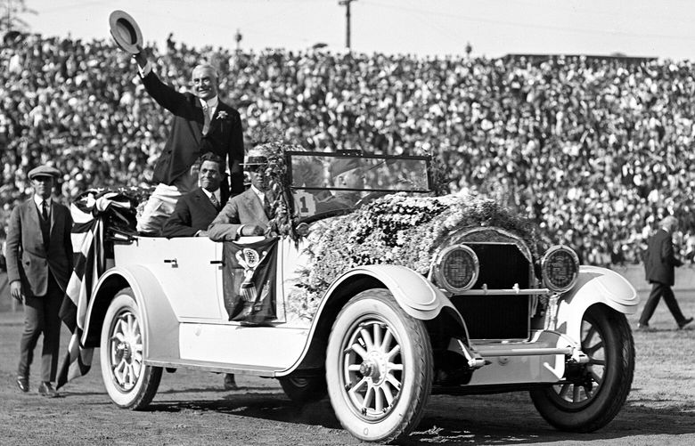 President Warren G. Harding waves to the crowd as his car circles Husky Stadium prior to his speech. (Webster & Stevens / Museum of History & Industry)