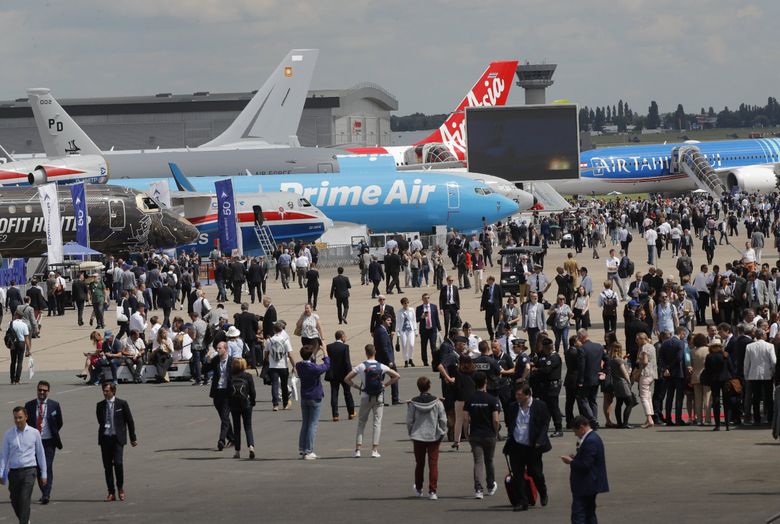 Visitors walk on the tarmac at Paris Air Show, in Le Bourget, France, northeast of Paris, in 2019. (Michel Euler / The Associated Press) 