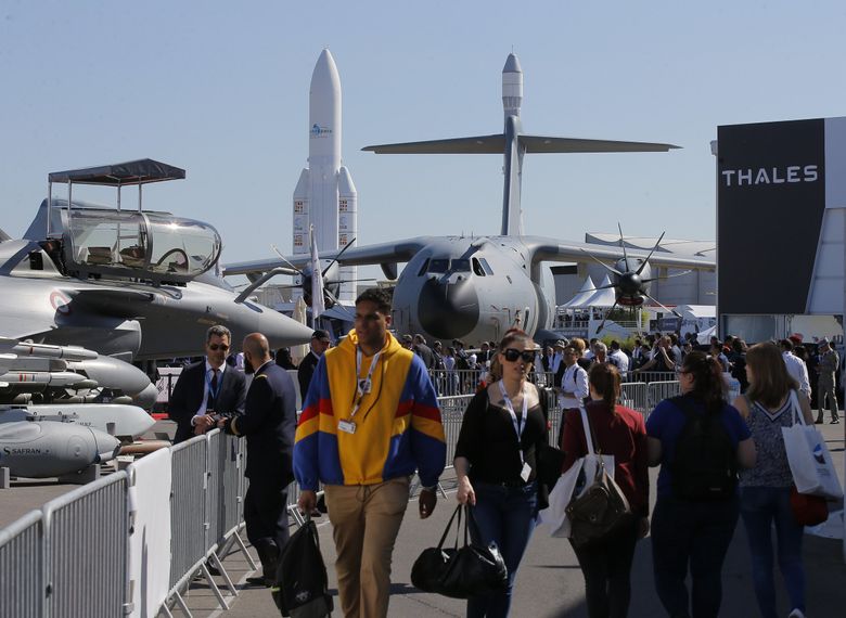 Visitors walk on the tarmac at Paris Air Show, in Le Bourget, France, northeast of Paris in 2019. (Michel Euler / The Associated Press) 