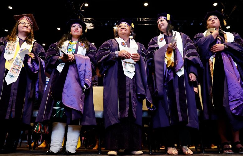 Members of the very first Muckleshoot Cohort, from left, Jennifer Vasilez, Joannie Marie Suina, Ada Marie McDaniel, Amy Maharaj and Merisa Jones stand as they look around the Events Center during their graduation ceremony.  224082