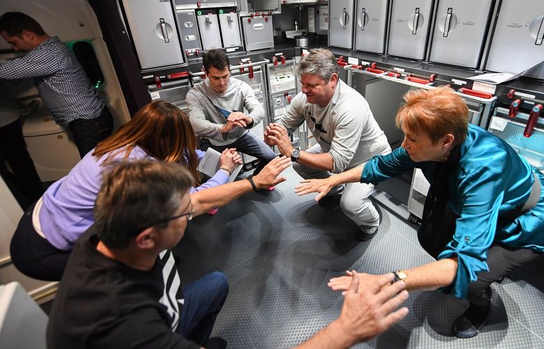 Passengers stay active on a Qantas research flight in 2019. MUST CREDIT: James D. Morgan/Qantas.