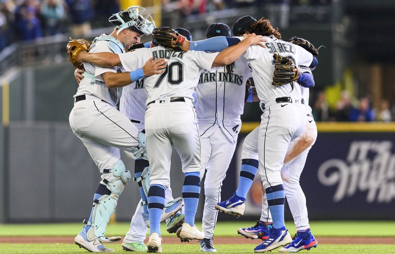 From left to right, Seattle Mariners’ Cal Raleigh, Ty Adcock (70) and Eugenio Suarez, dance after a victory over the Chicago White Sox in a baseball game, Sunday, June 18, 2023, in Seattle. (AP Photo/Caean Couto) WACC129 WACC129