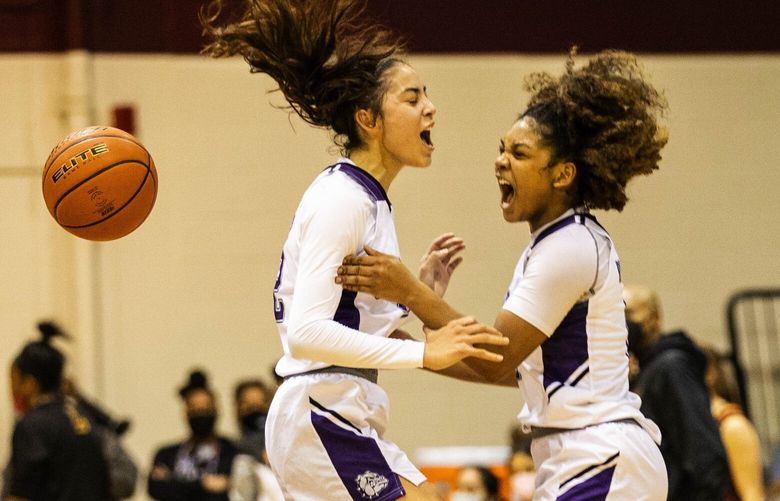 ­Garfield celebrates as time runs out on Lakeside’s comeback, giving the Lady Bulldogs the Metro League title. Katie Fiso, left, and Malia Samuels start the celebration at midcourt.
­
Garfield played Lakeside in the Girls Metro League Basketball Championship Friday, February 11, 2022 t Seattle Pacific University. 219497