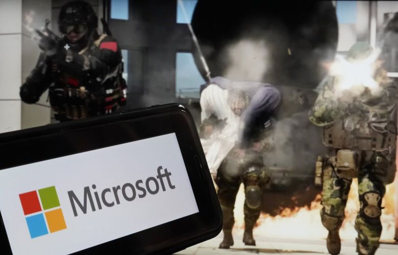 The logo for Microsoft, and a scene from Activision “Call of Duty – Modern Warfare,” are shown in this photo, in New York, Wednesday, June 21, 2023. (AP Photo/Richard Drew) 