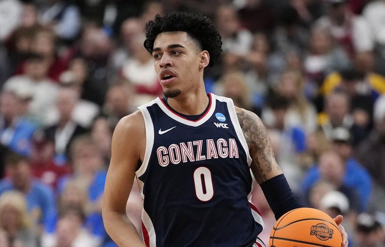 Gonzaga’s Julian Strawther (0) dribbles towards the basket in the first half of a Sweet 16 college basketball game against UCLA in the West Regional of the NCAA Tournament, Thursday, March 23, 2023, in Las Vegas. (AP Photo/John Locher)