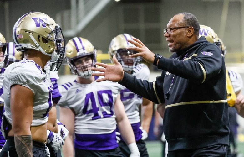 Assistant head coach William Inge talks with the linebacker corp Friday morning during spring practice at the Dempsey Indoor Center in Seattle, Washington on March 10, 2023.