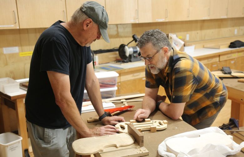 Instructor Clay Levit (right) and student Doug Salot discuss steps for Salot’s violin build. Salot teaches courses in BARN’s electronic and technical arts studio and has constructed acoustic and electric guitars, but this is his first time hand-carving an instrument.
