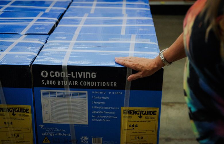 Debbie Park, 61, examines an air conditioning unit at McLendon Hardware in Renton, WA on July 24, 2022. The US National Weather Service has issued a heat advisory for Western Washington this week as temperatures are expected to rise.
