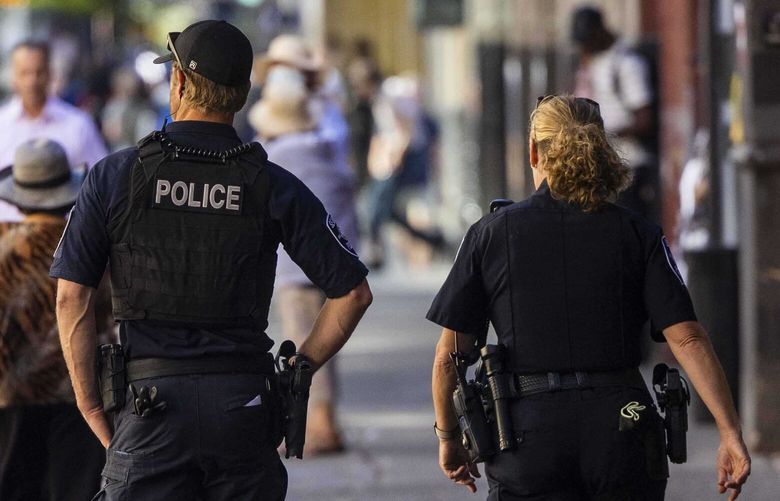 Seattle Police Department officers patrol 3rd Avenue in Seattle on Sept. 7, 2022.