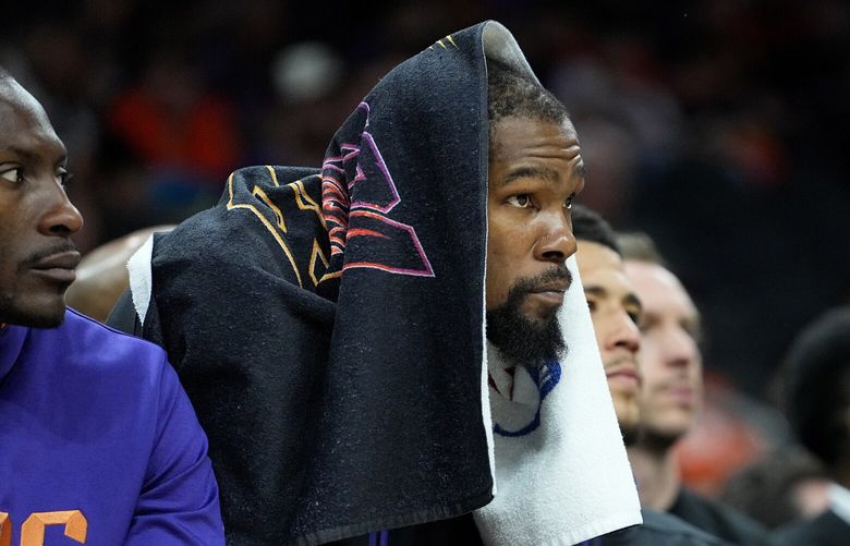 Phoenix Suns forward Kevin Durant watches from the bench during the second half of Game 6 of an NBA basketball Western Conference semifinal series against the Denver Nuggets, Thursday, May 11, 2023, in Phoenix. The Nuggets eliminated the Sun in their 125-100 win. (AP Photo/Matt York)