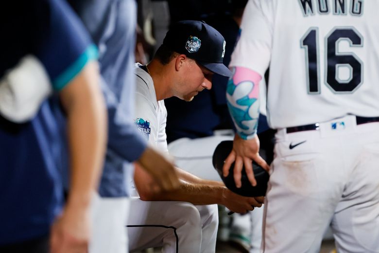 Seattle Mariners pitcher Trevor Gott sits in the dugout after giving up three runs to the Washington Nationals during the eleventh inning. (Jennifer Buchanan / The Seattle Times)