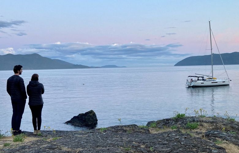 A couple soaks in the sunset colors at Doe Bay Resort and Retreat on Orcas Island, which commands one of the best views in the San Juans.