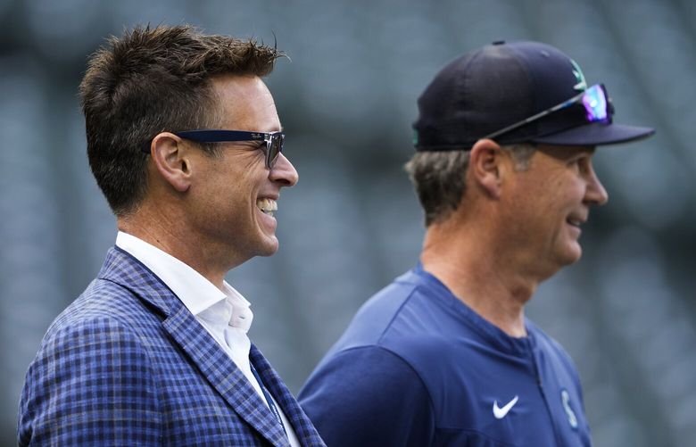 Seattle Mariners’ President of Baseball Operations Jerry Dipoto, left, laughs with manager Scott Servais before the team’s Opening Day baseball game against the Cleveland Guardians on Thursday, March 30, 2023, in Seattle. (AP Photo/Lindsey Wasson)