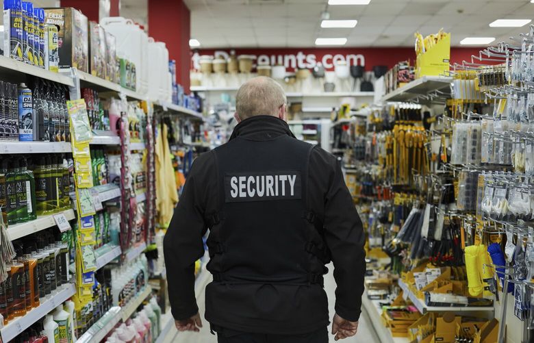 Security officer Simon Mackenzie working at a QD Store in Basildon, England, where they use Facewatch technology to identify past shoplifters, on June 28, 2023. The facial recognition system alerts Mackenzie, when someone on a shoplifting watchlist has entered. (Suzie Howell /The New York Times)