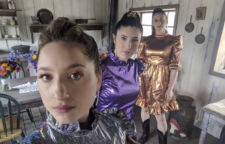 Rikki Gotthelf, from left, Laura Macshane, center, and Zoe Cohen appear at a wedding in Austin, Texas on March 30, 2019. The three were bridesmaids for the wedding of a friend in an abandoned ghost town. The guest dress code was “Space Cowboy Disco.” (Rikkie Gotthelf via AP). NYCL305 NYCL305