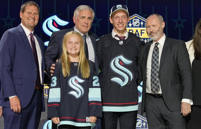 Eduard Sale, second from right, poses with Seattle Kraken officials after being picked by the team during the first round of the NHL hockey draft Wednesday, June 28, 2023, in Nashville, Tenn. (AP Photo/George Walker IV) TNGW156 TNGW156