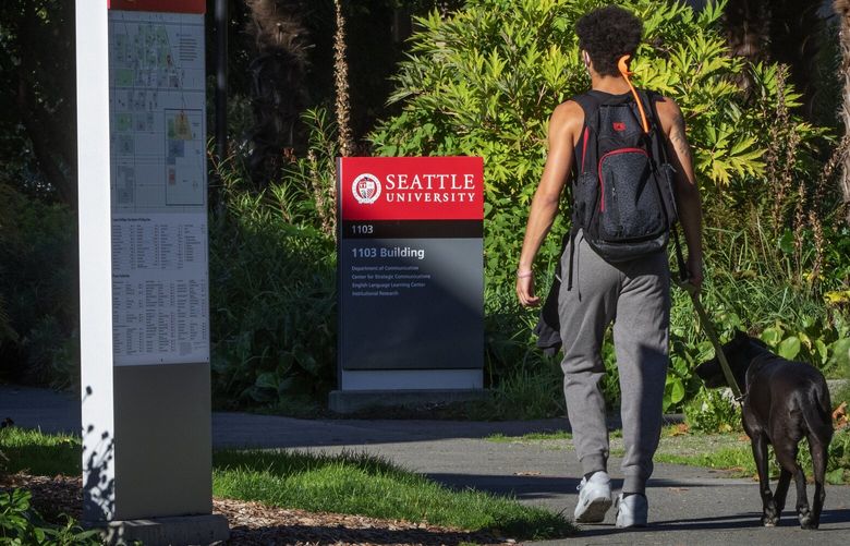 Crowds hanging outside at Seattle University are smaller in Seattle Thursday, October 15, 2020.   College enrollment, which is down only slightly at most Washington campuses this year, is actually up at the UW Seattle. Most kids also seem to be returning to campus, even though 90% of classes are online.  215376
