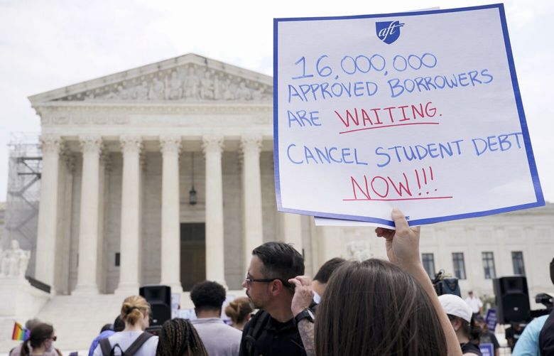 People demonstrate outside the Supreme Court, Friday, June 30, 2023, in Washington. A sharply divided Supreme Court has ruled that the Biden administration overstepped its authority in trying to cancel or reduce student loan debts for millions of Americans. Conservative justices were in the majority in Friday’s 6-3 decision that effectively killed the $400 billion plan that President Joe Biden announced last year. (AP Photo/Jacquelyn Martin) DCJM403 DCJM403