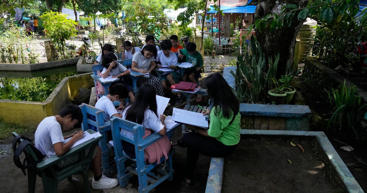 Students meet under trees as schools shelter villagers displaced by ...