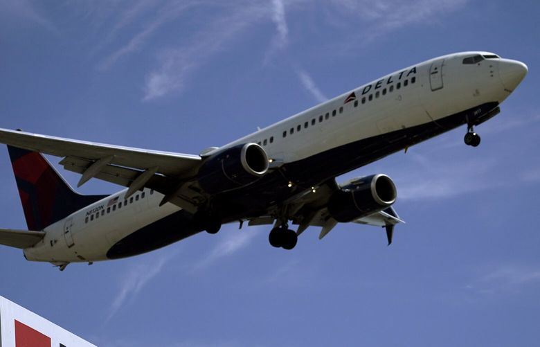 A Delta Air Lines jet prepares to land at Los Angeles International Airport, in Los Angeles, Tuesday, March 15, 2022. Airline passengers dealing with weather delays could be facing a new source of disruptions this weekend. Wireless providers plan to power up new 5G systems near major airports on Saturday, July 1, 2023. (AP Photo/Damian Dovarganes) 