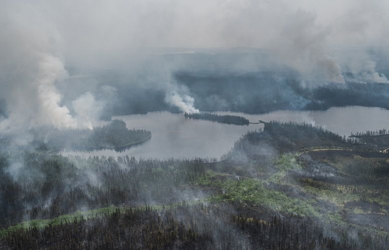 FILE — Wildfires burning in northern Quebec, Canada, June 14, 2023. Wildfires are hurting many industries and could strain households across Canada, one of many countries reckoning with the impact of extreme weather. (Renaud Philippe/The New York Times) XNYT0658 XNYT0658