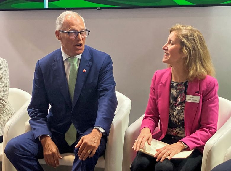 Gov. Jay Inslee speaks with Sheila Remes, Boeing vice president of environmental sustainability, as they prepare to speak at the Paris Air Show on a panel about aviation sustainability on June 20, 2023.  (Dominic Gates / The Seattle Times)