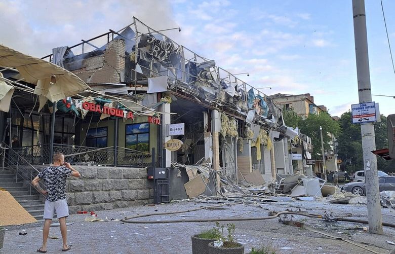 FILE  – In this photo provided by the Ukrainian Donetsk Regional Administration, a man stands on a street in front of a shop and restaurant RIA Pizza destroyed by a Russian attack in Kramatorsk, Ukraine, Tuesday, June 27, 2023. The PEN America rights group says award-winning Ukrainian writer Victoria Amelina has died from her injuries suffered after a Russian missile attack on a popular restaurant on Tuesday, June 27, 2023. (Ukrainian Donetsk Regional Administration via AP, File) AMB101 AMB101