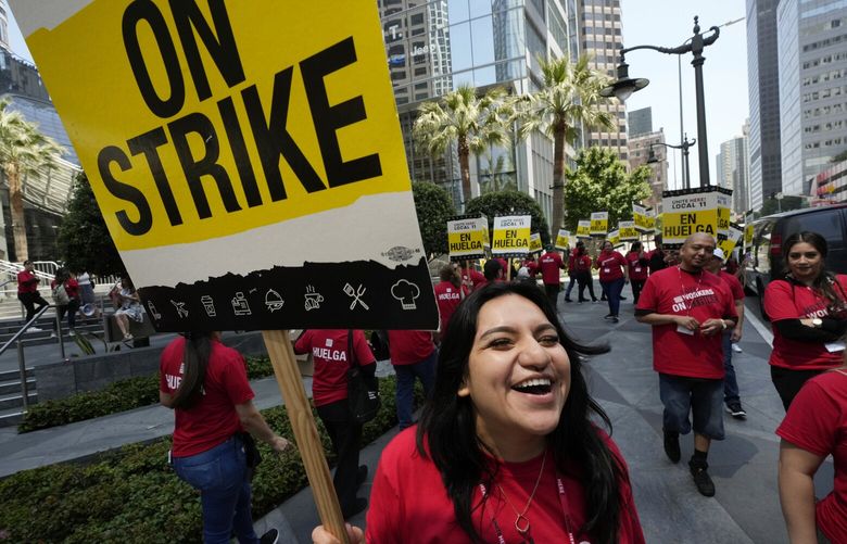 Striking hotel workers rally outside the Intercontinental Hotel after walking off their job early Sunday, July 2, 2023, in downtown Los Angeles. (AP Photo/Damian Dovarganes) CADD107 CADD107