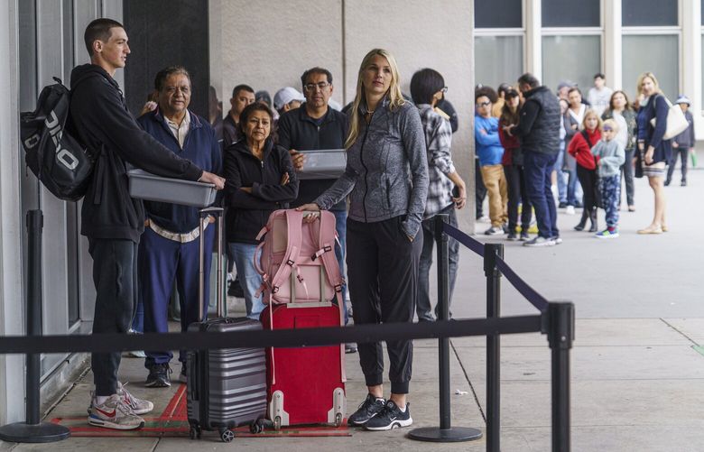 Marni Larsen and her son, Damon Rasmussen of Holladay, Utah, wait their turn in line hoping to snag her son’s passport outside the Los Angeles Passport Agency at the Federal Building in Los Angeles on Wednesday, June 14, 2023.  Larsen applied for her son’s passport two months earlier and spent weeks checking for updates online or through a frustrating call system. (AP Photo/Damian Dovarganes) CADD105