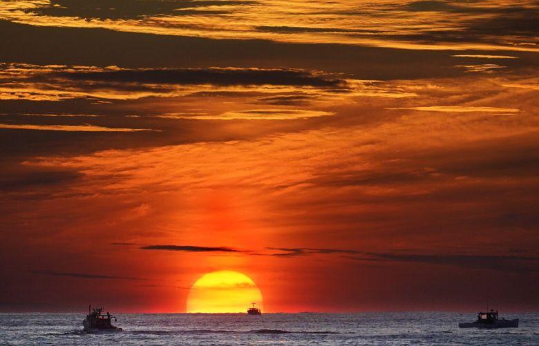 FILE – The sun rises over fishing boats in the Atlantic Ocean, Sept. 8, 2022, off of Kennebunkport, Maine. The United Nations body that regulates the world’s ocean floor is preparing to resume negotiations in July 2023, that could open the international seabed for mining, including for materials vital for the green energy transition. (AP Photo/Robert F. Bukaty, File) CLI101 CLI101