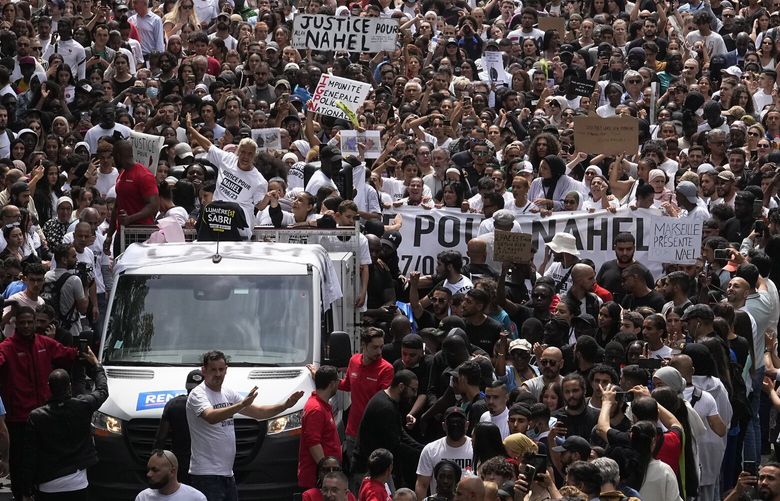 FILE – The mother of killed 17-year-old Nahel, center on truck, gestures during a march for Nahel, Thursday, June 29, 2023 in Nanterre, outside Paris. The killing of Nahel during a traffic check Tuesday, captured on video, shocked the country and stirred up long-simmering tensions between young people and police in housing projects and other disadvantaged neighborhoods around France. After more than 3,400 arrests and signs that the violence is now abating, France is once again facing a reckoning. (AP Photo/Michel Euler, File) ASOB107 ASOB107