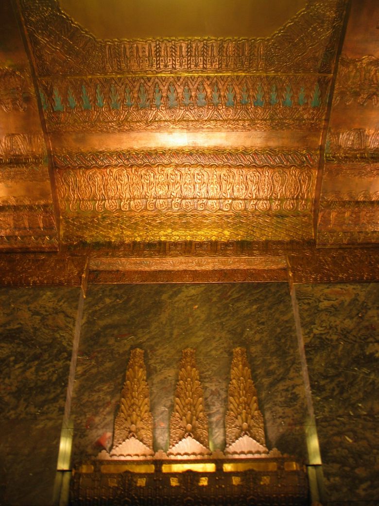 THE SEATTLE TOWER: Throughout the interior, symbols of the evergreen forest of the Pacific Northwest are stylistically represented in bronze and plaster. (Lawrence Kreisman)