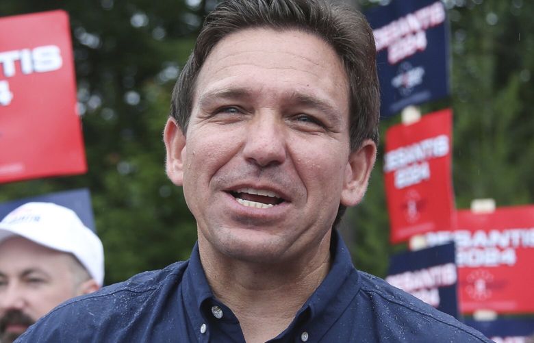 FILE – Republican presidential candidate and Florida Gov. Ron DeSantis and his wife Casey, walk in the July 4th parade, July 4, 2023, in Merrimack, N.H. DeSantis is defending an anti-LGBTQ video his campaign shared online that attacks rival Donald Trump for his past support of gay and transgender people, despite some of his fellow Republicans calling it homophobic. (AP Photo/Reba Saldanha, File) NHRS111 NHRS111