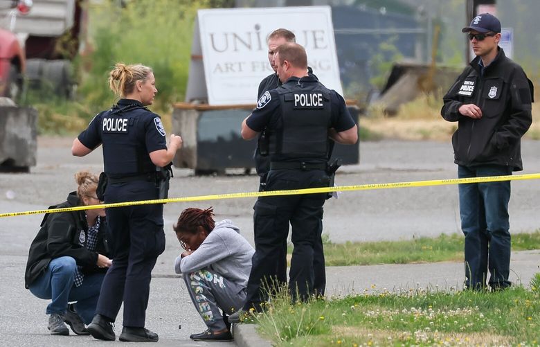 A family member interviewed by police while investigating a shooting Airport Way and S Hinds St. Saturday morning in Seattle, Washington on July 8, 2023. The second shooting in SODO in the last 24 hours.
