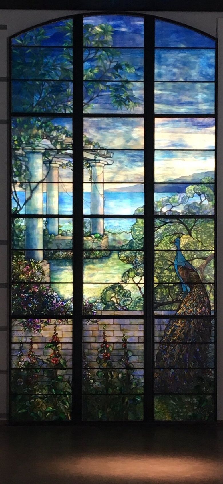 THE JOHN AND ELIZA LEARY MANSION: Into the great hall&#8217;s essentially Renaissance Revival setting, the architect incorporated a monumental nine-light stained-glass window of a peacock in a garden by Louis Comfort Tiffany. (Lawrence Kreisman)